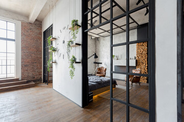 luxury studio apartment with a free layout in a loft style in dark colors. Stylish modern kitchen...