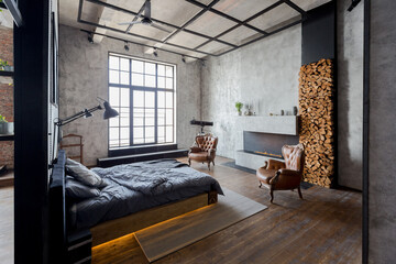 luxury studio apartment with a free layout in a loft style in dark colors. Stylish modern kitchen...