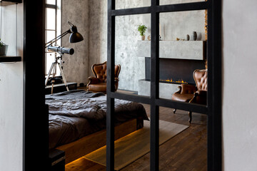 luxury studio apartment with a free layout in a loft style in dark colors. Stylish modern kitchen...