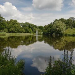 Vondelpark lake view with water reflection including blue cloudy sky