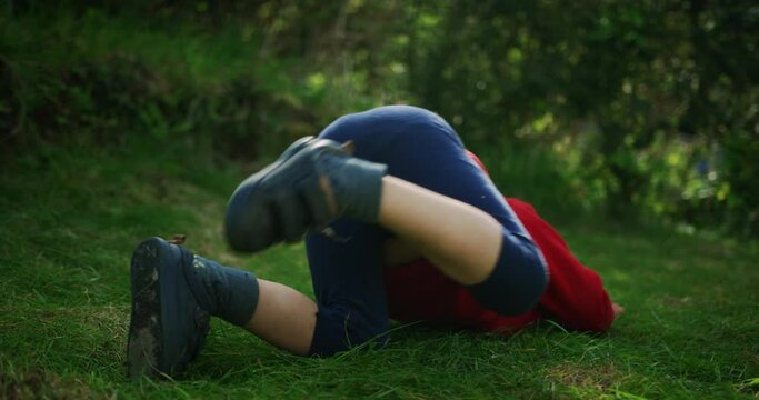 Little boy lying on the grass in the springtime