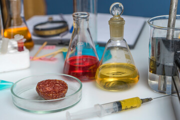 Workplace of a laboratory assistant, test tubes and laboratory equipment. Food laboratory. Close up on a white table.