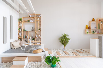 Luxury fashionable modern design studio apartment with a free layout in a minimal style. very bright huge spacious room with white walls and wooden elements. sitting area with fireplace