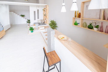 Luxury fashionable modern design studio apartment with a free layout in a minimal style. very bright huge spacious room with white walls and wooden elements. sitting area with fireplace