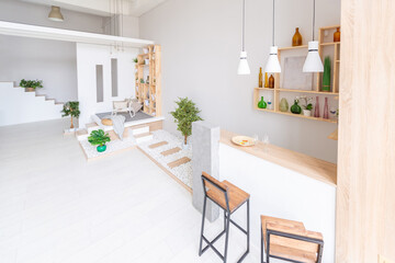 Luxury fashionable modern design studio apartment with a free layout in a minimal style. very bright huge spacious room with white walls and wooden elements. sitting area with fireplace