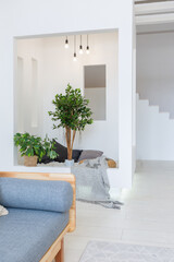 Luxury fashionable modern design studio apartment with a free layout in a minimal style. very bright huge spacious room with white walls and wooden elements. sitting area with fireplace