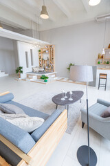 Luxury fashionable modern design studio apartment with a free layout in a minimal style. very bright huge spacious room with white walls and wooden elements. sitting area with fireplace