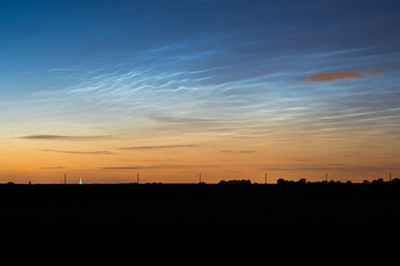 Electric blue: noctilucent clouds (NLC) or night shining clouds with waves and ripples in the night sky
