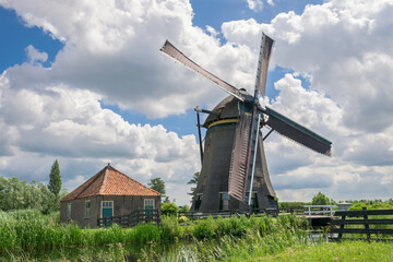 Fototapeta na wymiar Classic dutch windmill with clouds in the background. Mill is named 