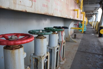 Valves for opening and closing fuel and ballast tanks on the main deck of merchant container ship