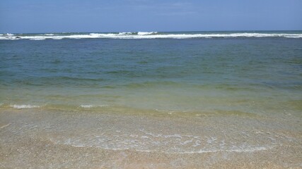 Beach with low tide.Soft sea wave with beach in Sri Lanka.