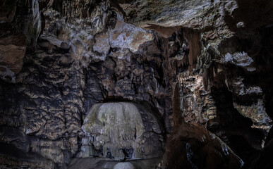 Inside the mysterious flowstone cave 'Nebelhöhle' with stalagmites and stalactites in Germany.
