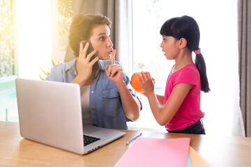 a mother telecommuting at home who is disturbed on the cell phone by her daughter