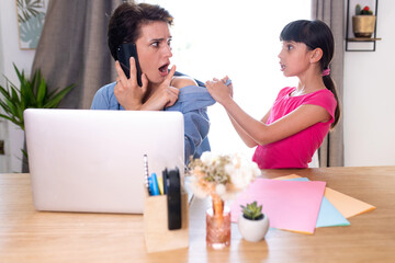 a mother telecommuting at home who is disturbed on the cell phone by her daughter