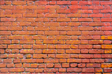 Wall of red brick. Designer interior background. Abstract architectural surface.
