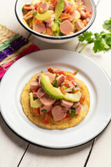 Mexican sausage ceviche with avocado on white background