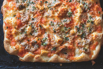 Fresh home-baked pizza on a baking sheet straight from the oven