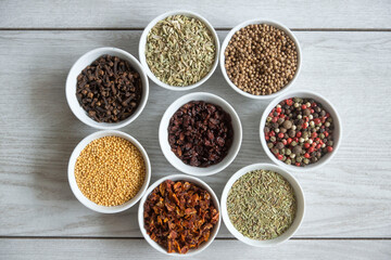 Dry seasonings and spices against a dark background view from the top.