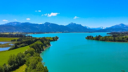 Fototapeta na wymiar Aerial view over Lake Forggensee at the city of Fuessen in Bavaria Germany