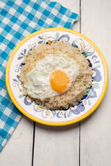 Fried egg with rice on white background