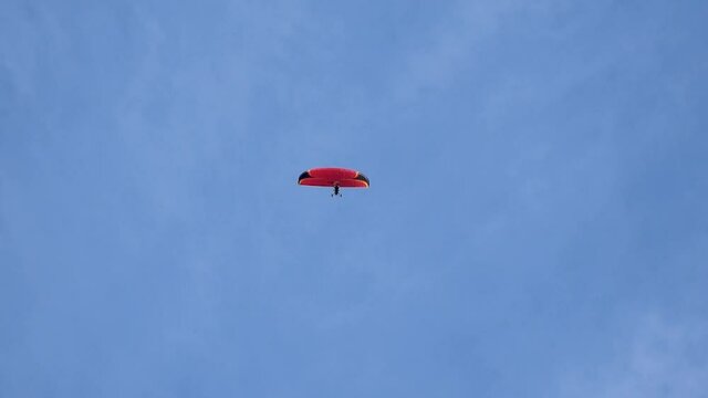 paraglider flies alone in clear blue sky