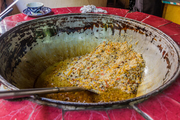 Cooking of plov in the Kazan cauldron in Tashkent, Uzbekistan