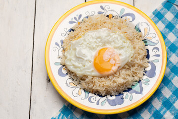 Fried egg with rice on white background