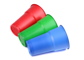 Set of plastic cups isolated. Red, green and blue plastic glasses