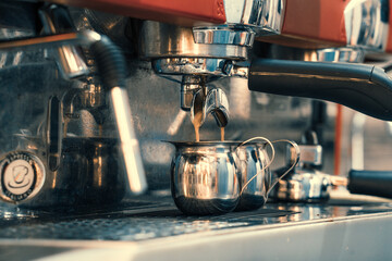 
Steamed coffee machine, barista makes coffee in a cafe