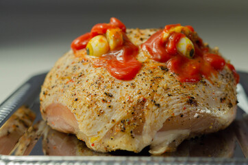 Prepared meat for Halloween party, raw chicken crown with a salt and pepper seasoning and peppercorn butter