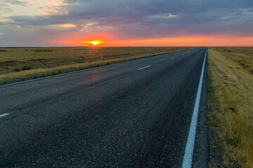 Fototapeta na wymiar Sunset view of a road in russian steppe