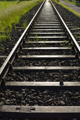 Fototapeta premium Railway tracks between green fields