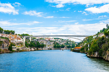 Obraz premium It's Architecture over the coast of the River Douro in Porto, Portugal. View from the River Douro, one of the major rivers of the Iberian Peninsula (2157 m)