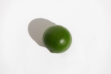 Raw green lime on white background