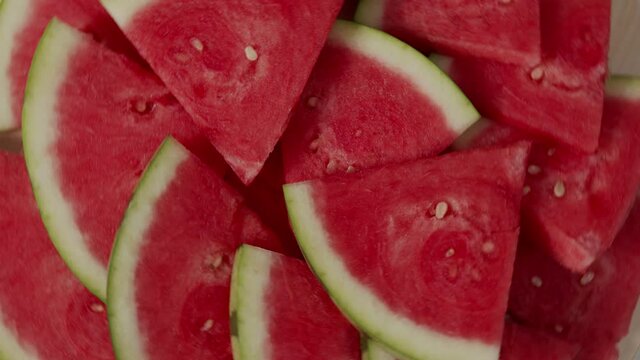 slices of watermelon rotate top view on a table