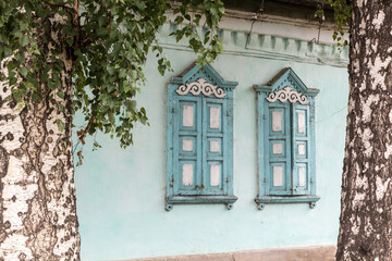 Fototapeta na wymiar Windows of an old house in Karakol, Kyrgyzstan