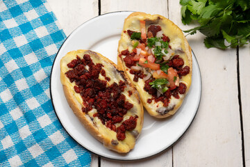 Mexican molletes with chorizo and fresh sauce on white background