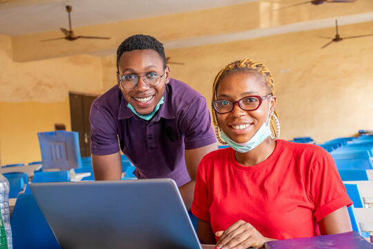 portrait of students in a classroom smiling, wearing face masks