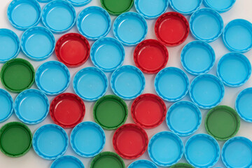 Color covers for plastic bottles for drinks on white background. Flat view.