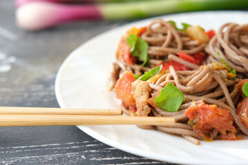 Japanese buckwheat noodle soba with vegetables, chicken meat, soy sauce and greens. Healthy...