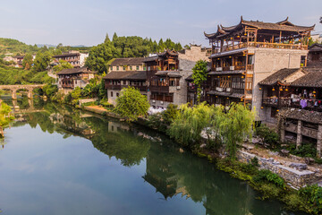 Fototapeta na wymiar Traditional houses reflecting in a river in Furong Zhen town, Hunan province, China