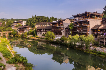 Fototapeta na wymiar Traditional houses reflecting in a river in Furong Zhen town, Hunan province, China