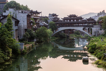 Fototapeta premium Old bridge reflecting in a river in Furong Zhen town, Hunan province, China