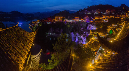 Fototapeta premium Evening view of Furong Zhen town and waterfall, Hunan province, China