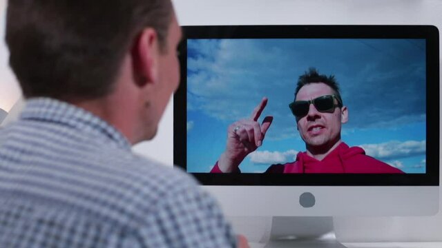 Two friends are talking on an online call. A man talks about a vacation in the village in self-isolation. Communication over a long distance.  Online call. Video communication over a long distance.