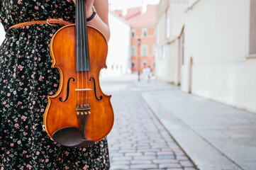 Obraz na płótnie Canvas Violin close-up, woman playing the violin.