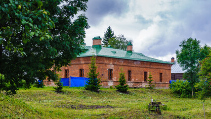 Red bricks Russian building on the green grass