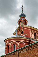 Fototapeta na wymiar Red wall surrounding the Orthodox monastery in Old Ladoga town, Russia