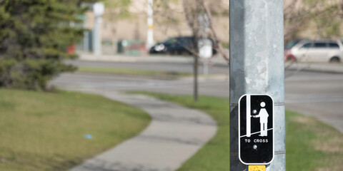 Road crossing sign at street intersection for pedestrians to cross road