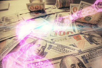 Double exposure of man wearing VR glasses drawing over usa dollars bill background. Concept of virtual reality.